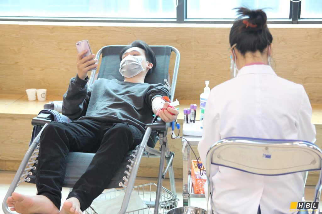 A man is giving blood at the blood donation event